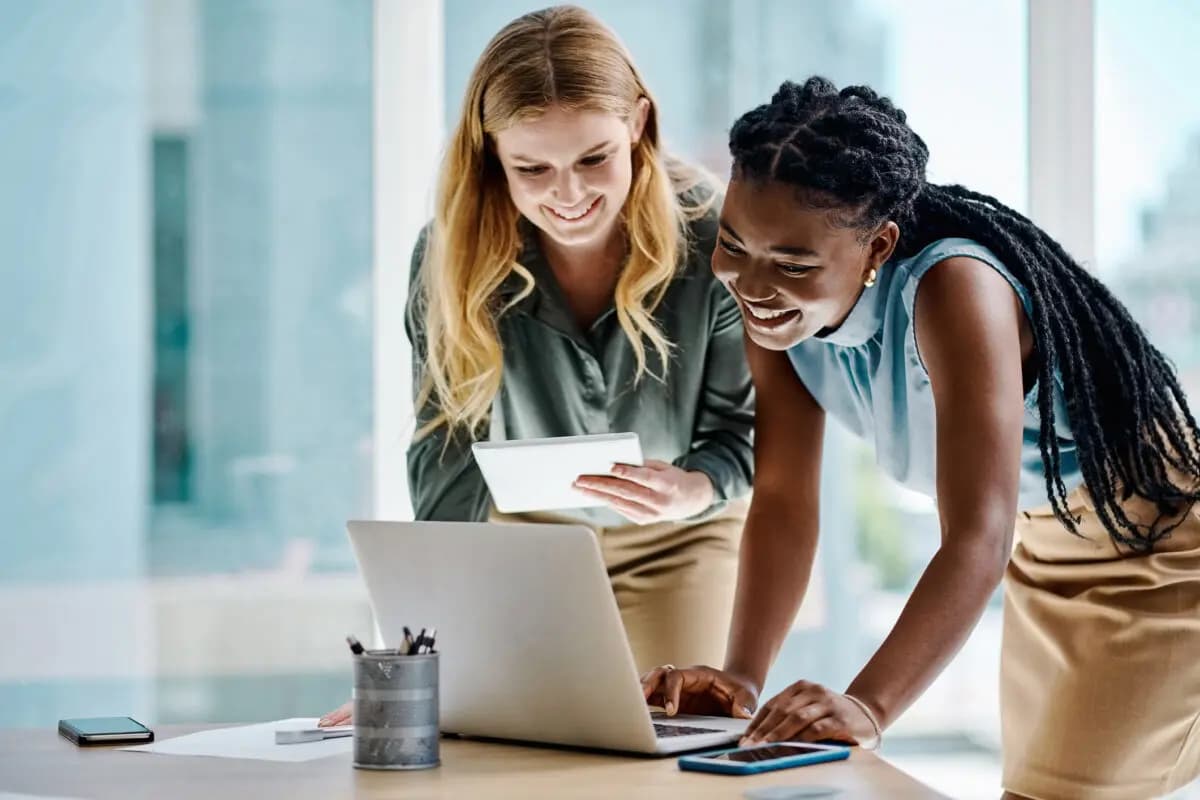 Two females looking at a laptop