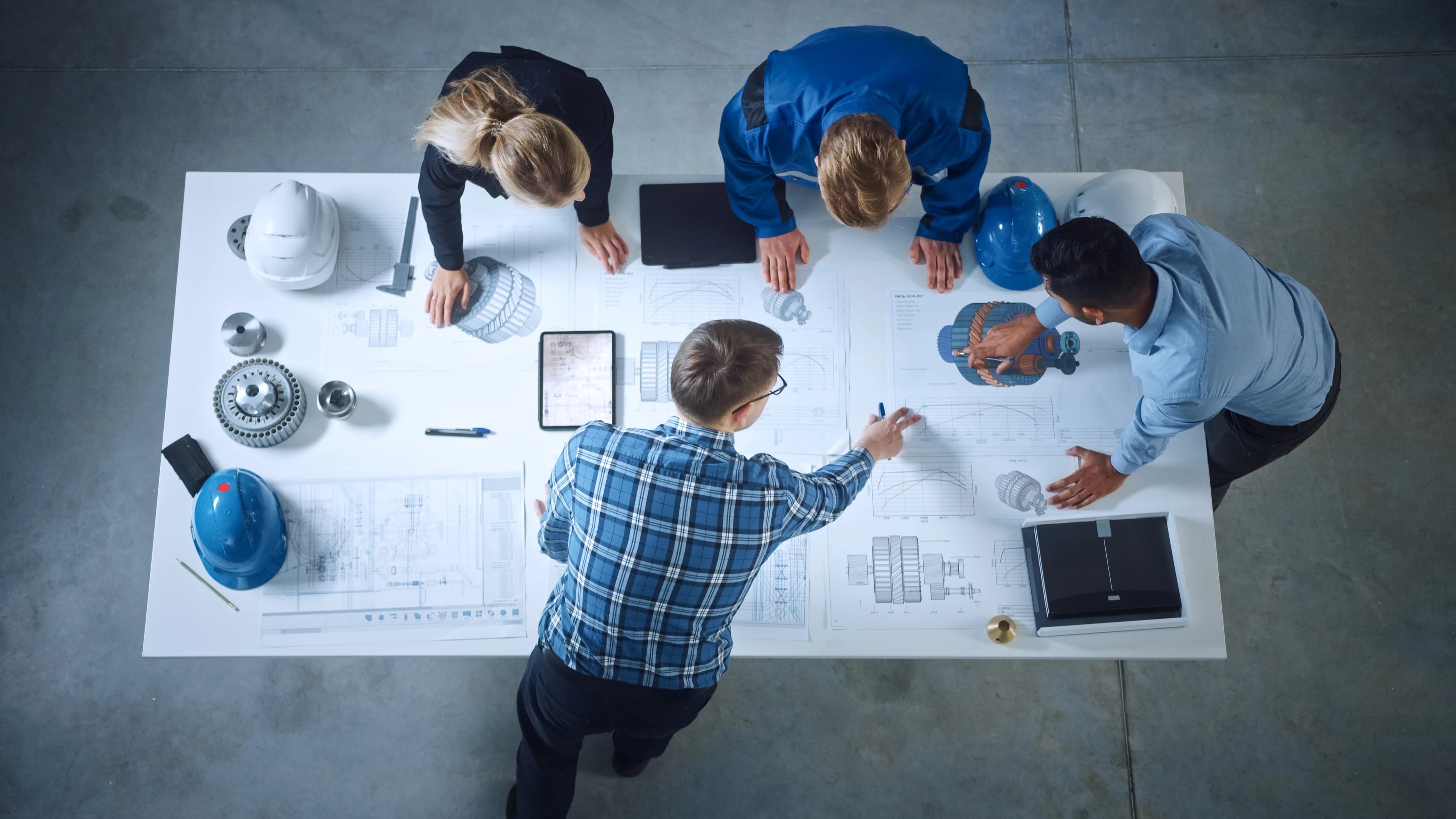 Four construction workers looking at an drawings
