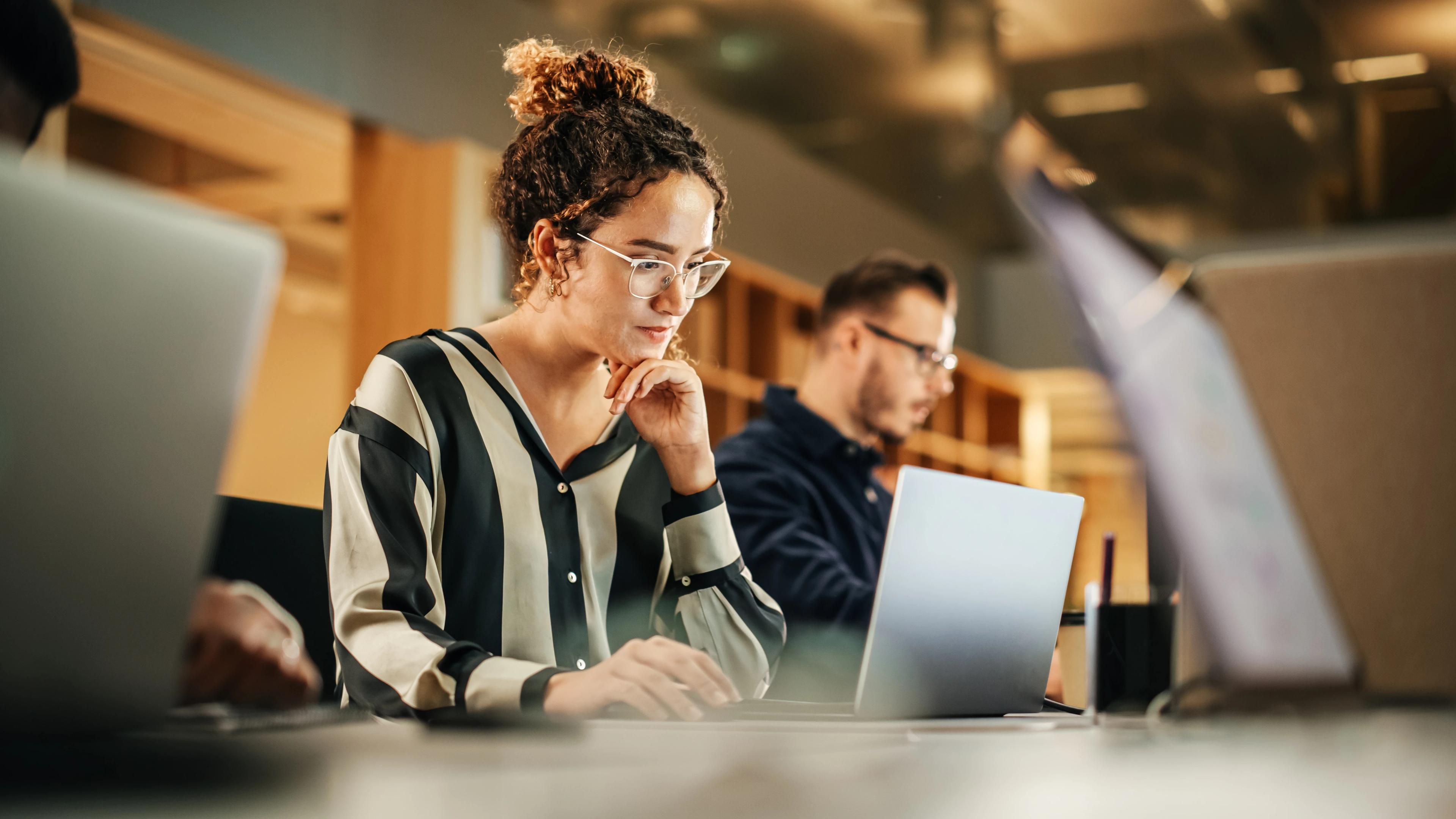 Female executive sitting at a laptop