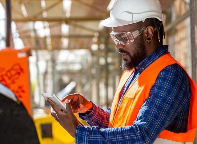 Construction worker looking at his iPad - 1000px